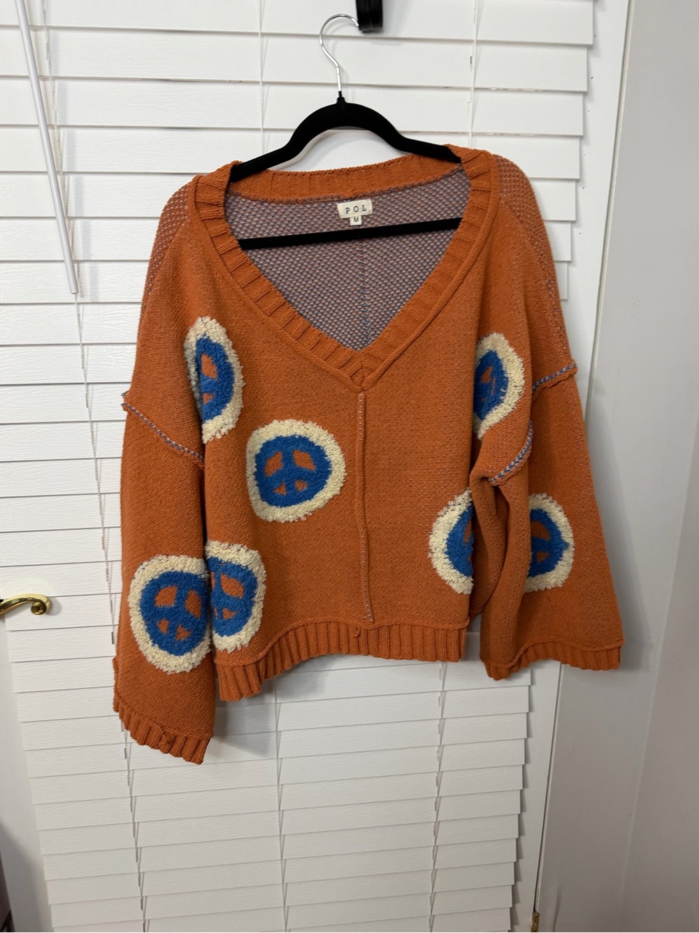 POL Rust Orange V-Neck Sweater with Blue and Cream Motifs